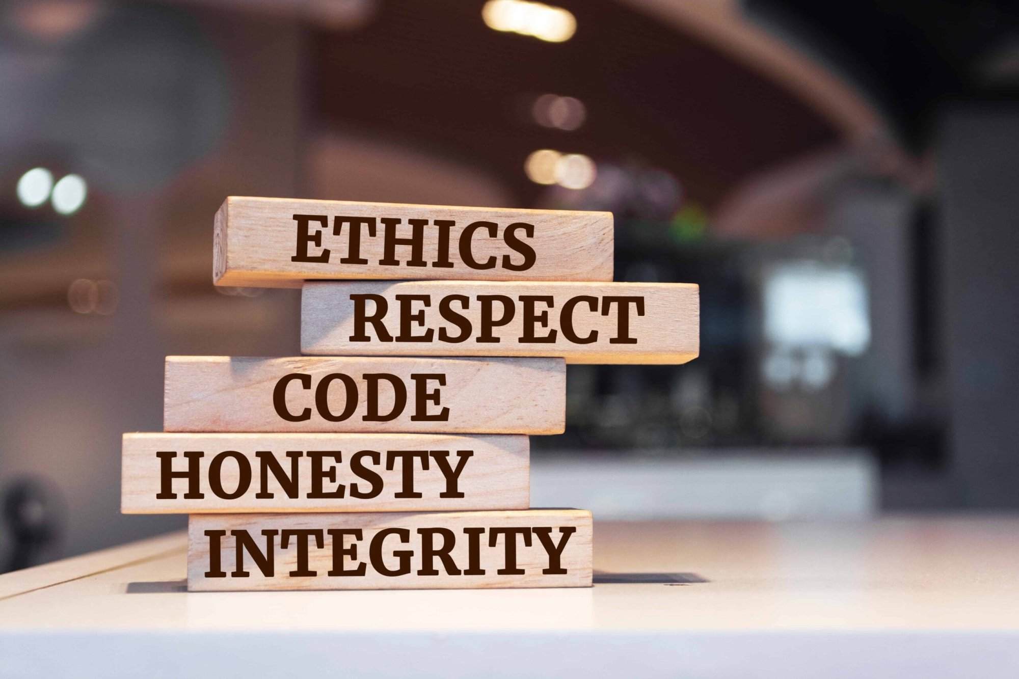 Wooden blocks with words 'ethics, respect, code, honesty, integrity'. code of conduct