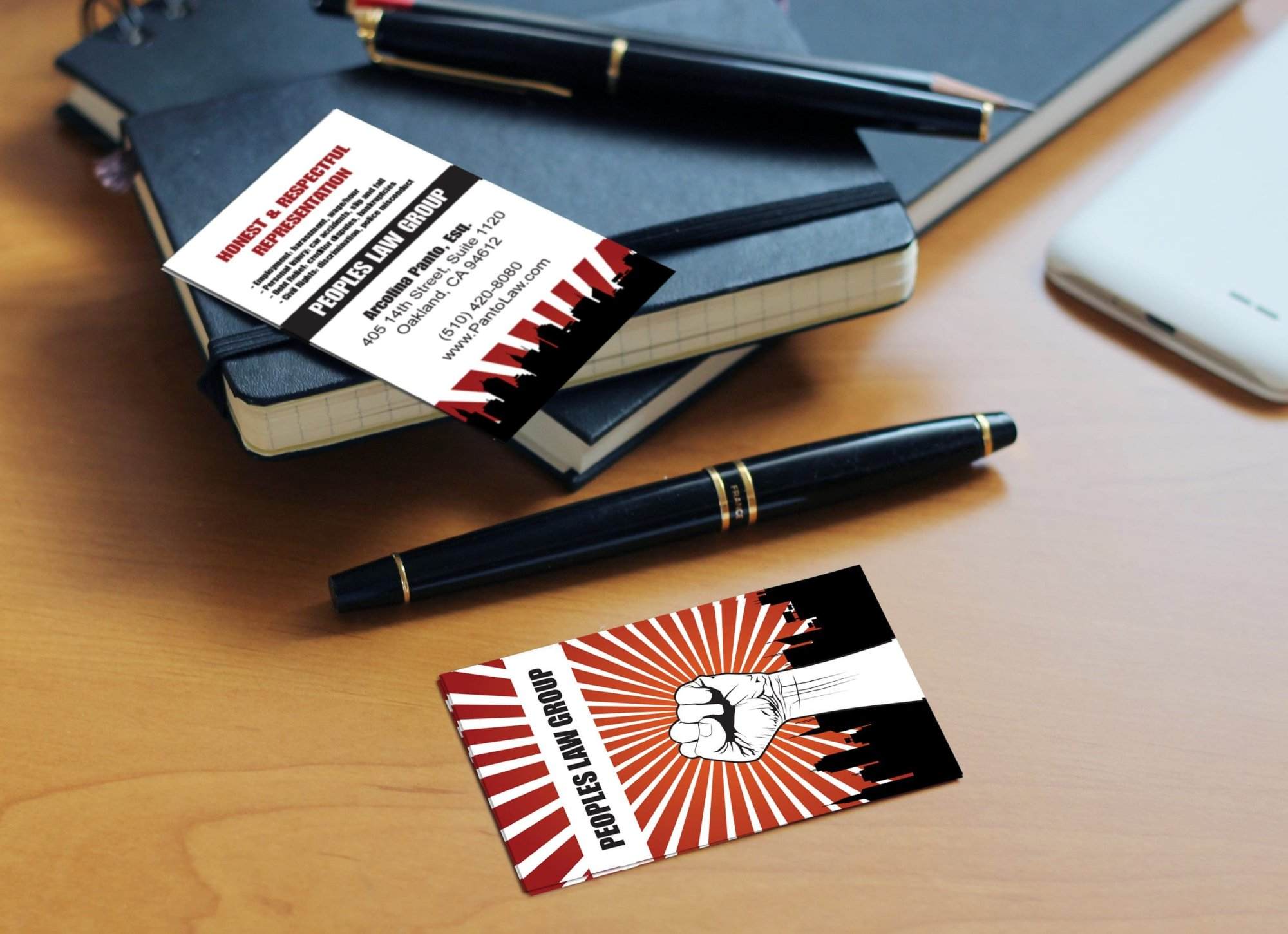 Portfolio Two “PEOPLE’S LAW GROUP” business cards on a desk with pens, notebooks, and a smartphone; one card features a fist illustration with a city skyline—ideal inspiration for small business website design or WordPress web designer portfolios.All-inclusive Website Design Services