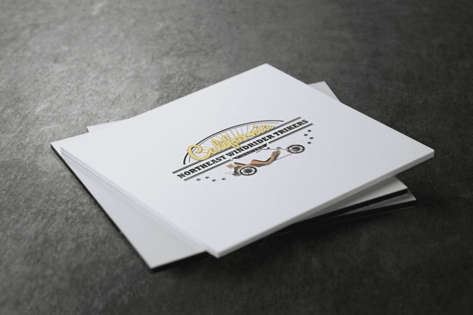 Portfolio A square booklet with a “California Northeast Winddipper Triker” logo, trike illustration, and decorative stars graces the cover—an inspiring piece for any web designer near me—resting on a dark textured surface.All-inclusive Website Design Services