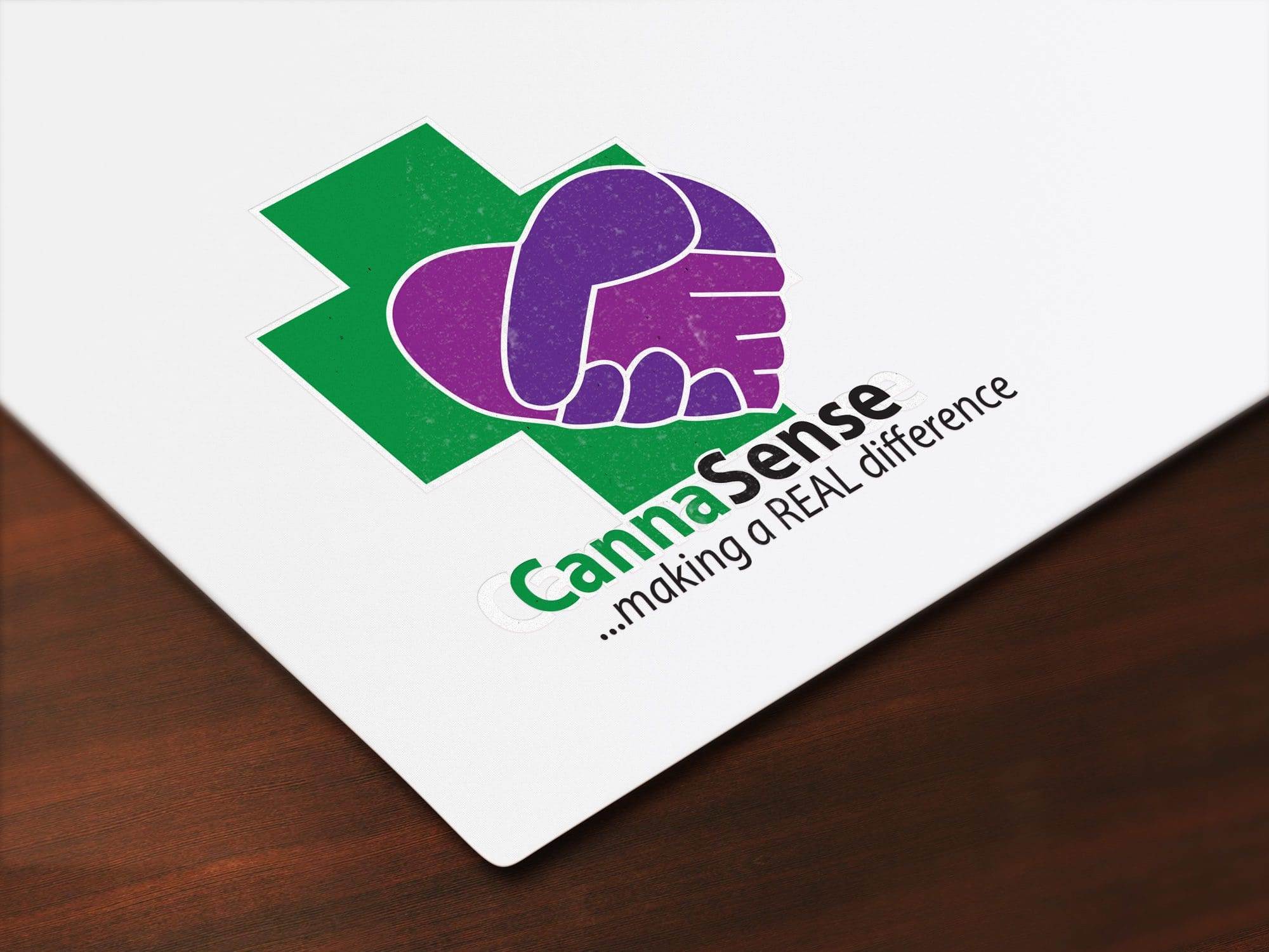 Portfolio Logo with a green medical cross, purple handshake inside a heart, and text: “CannaSense …making a REAL difference” on white—crafted to stand out by a professional website design company.All-inclusive Website Design Services