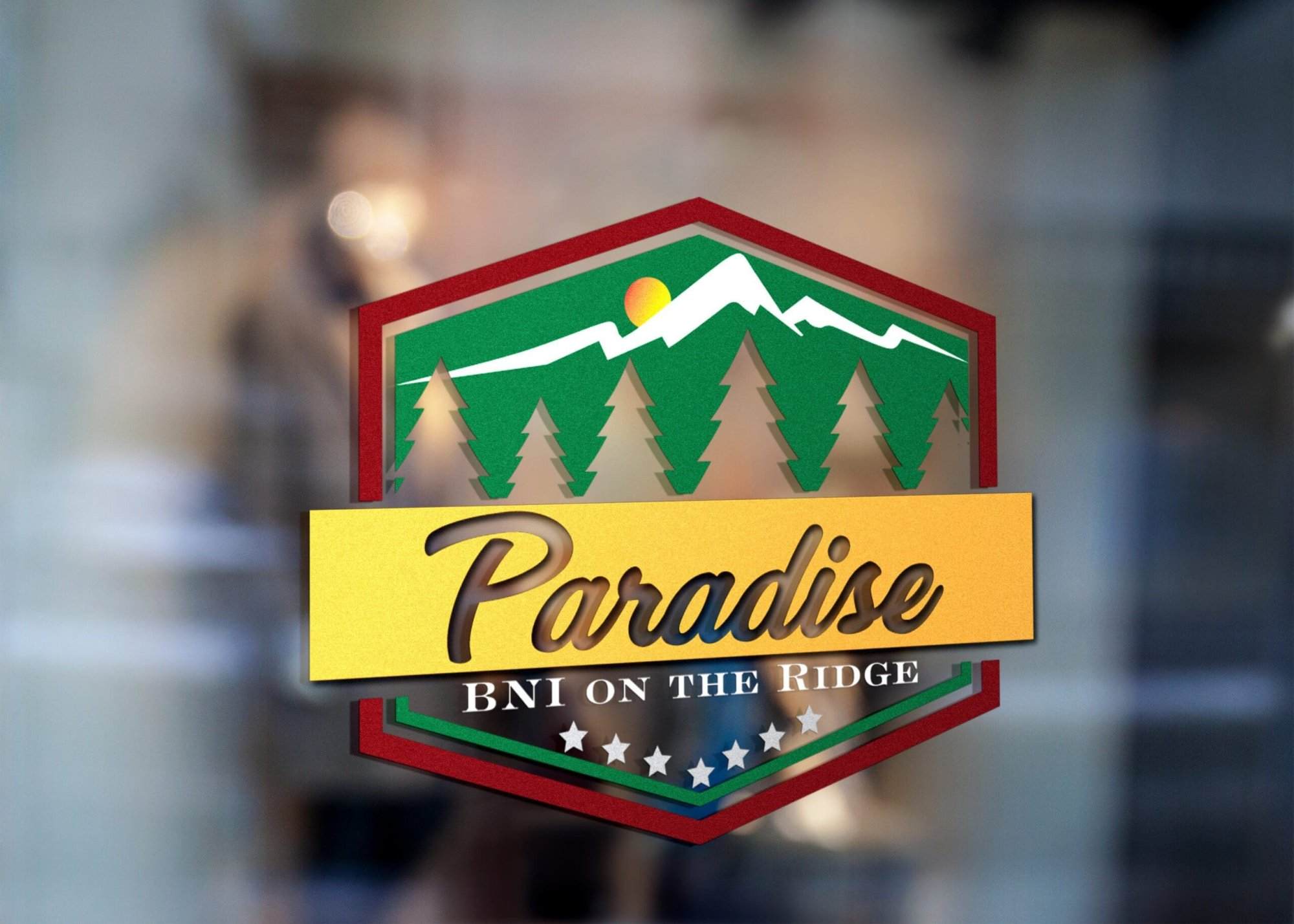 Portfolio A logo with pine trees, a mountain, and sun design. “Paradise” in gold script tops “BNI ON THE RIDGE,” with a row of white stars below—perfect for a WordPress web designer or those seeking affordable web design services.All-inclusive Website Design Services