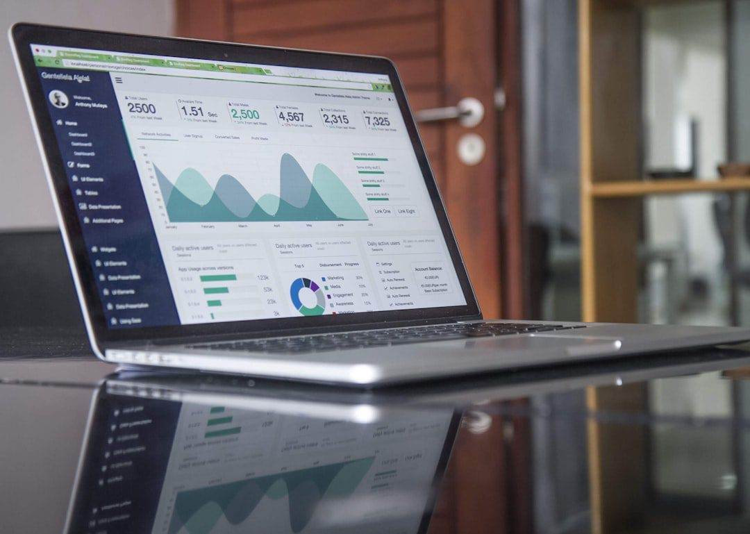 Unlocking the Power of Domain-Branded Email Accounts A laptop on a glass table displays a data analytics dashboard with charts, ideal for a WordPress web designer focused on small business website design and efficient website maintenance and support.