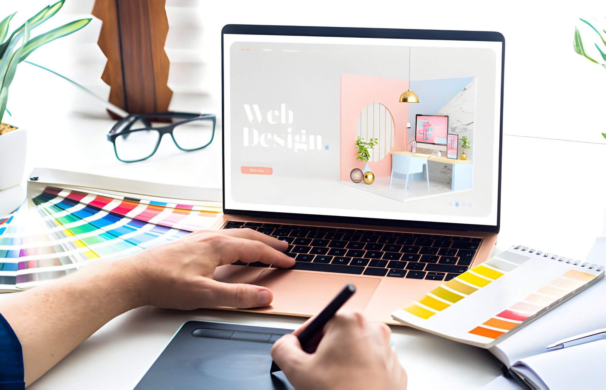 Unlocking Digital Success: How Professional Website Design Elevates Your Business A WordPress web designer uses a graphic tablet and laptop displaying a web design page, surrounded by color swatches, a notepad, eyeglasses, and plants—reflecting affordable web design services in action.